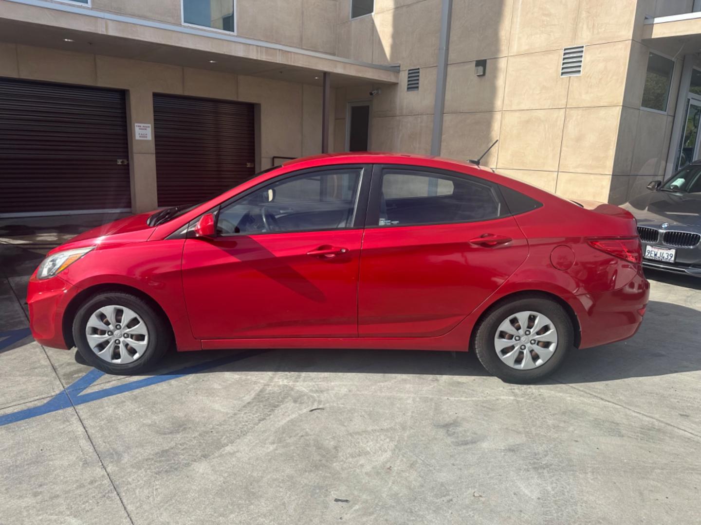 2015 Red /Gray Hyundai Accent GLS Sedan 4D (KMHCT4AE2FU) with an 4-Cyl, 1.6L engine, Auto, 6-Spd w/Overdrive transmission, located at 30 S. Berkeley Avenue, Pasadena, CA, 91107, (626) 248-7567, 34.145447, -118.109398 - The 2015 Hyundai Accent 4-Door Sedan stands as a testament to Hyundai's commitment to quality, efficiency, and value. Located in Pasadena, CA, our dealership specializes in providing a wide range of used BHPH (Buy Here Pay Here) cars, trucks, SUVs, and vans, including the remarkable Hyundai Accent. - Photo#2